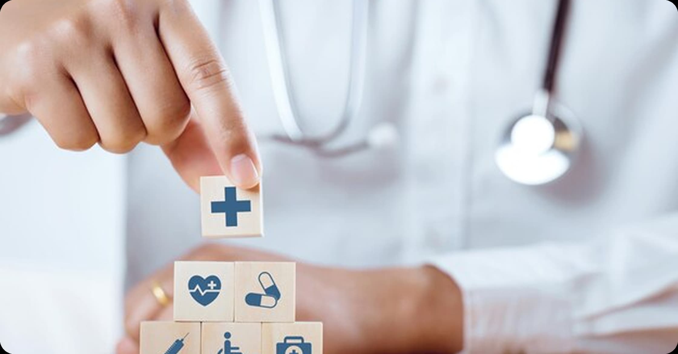 Doctor stacking healthcare symbol blocks